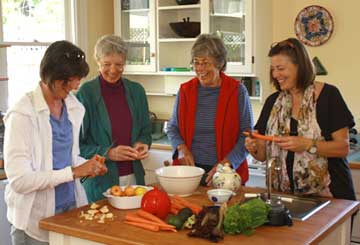 women in kitchen preparing food
